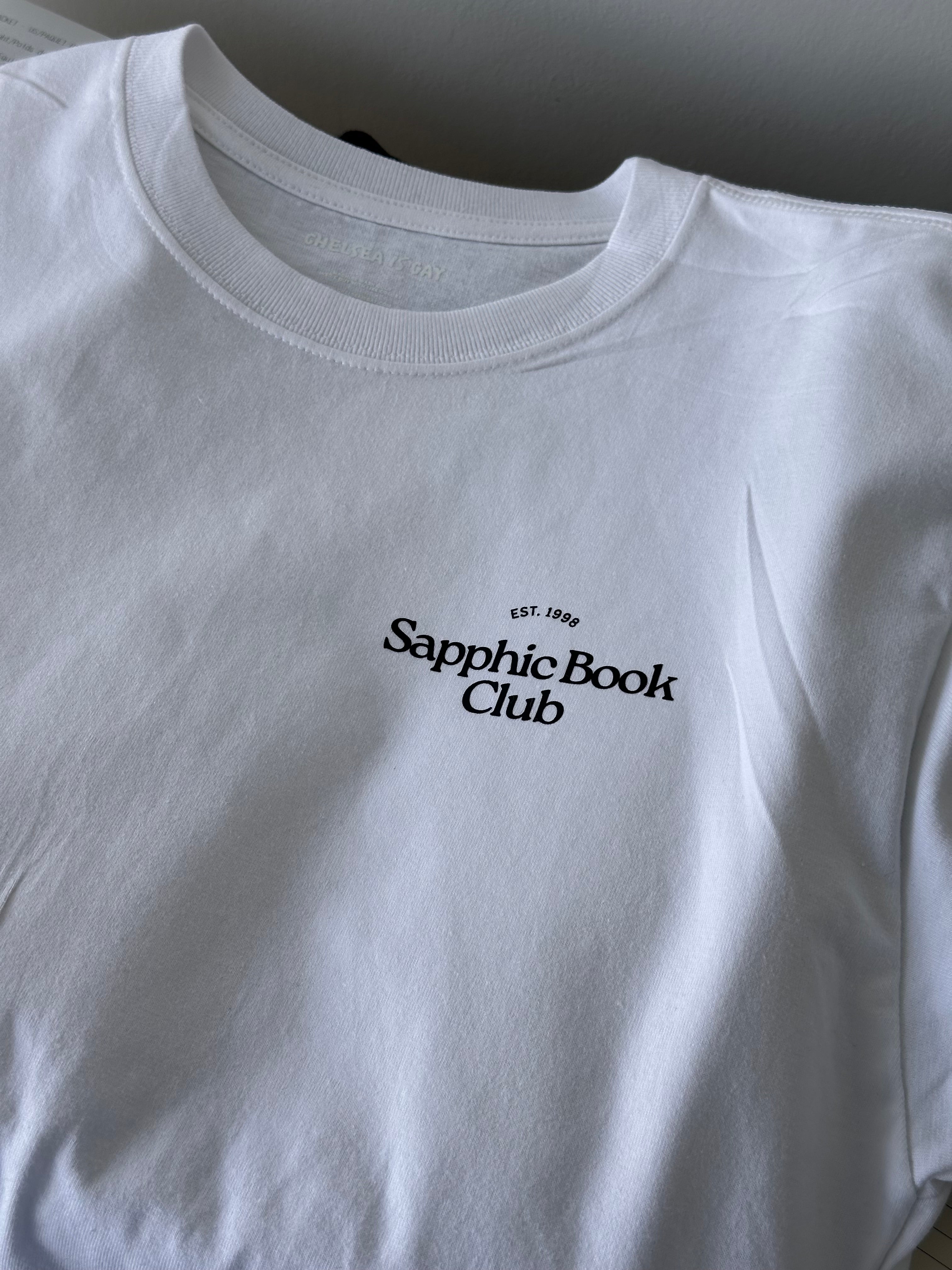 White tshirt with 'Sapphic Book Club' text on a plain background