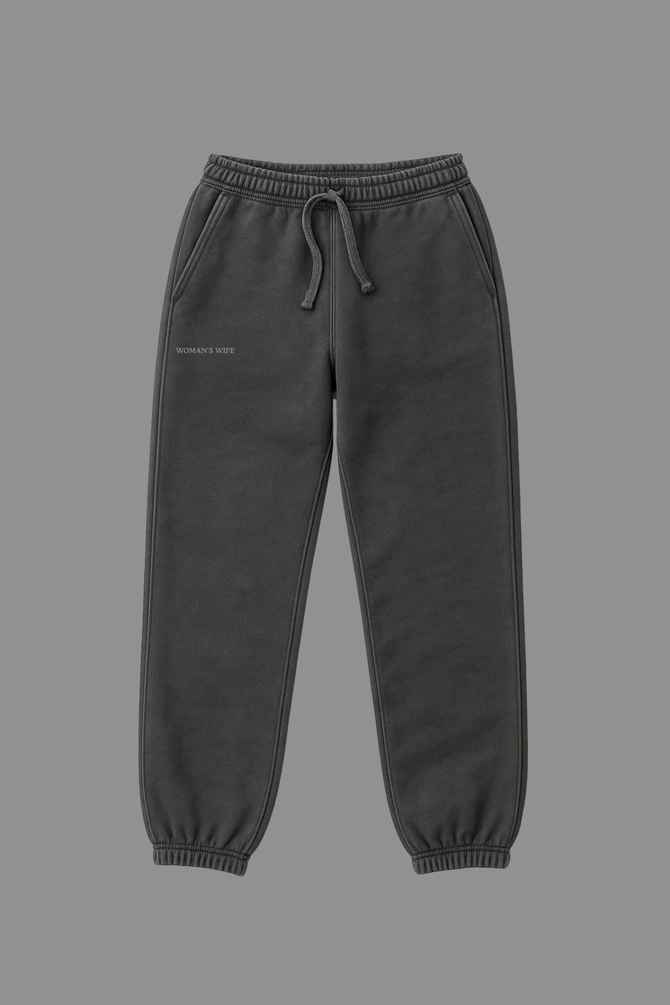 Dark grey sweatpants with a WOMAN'S WIFE embroidered on a grey background